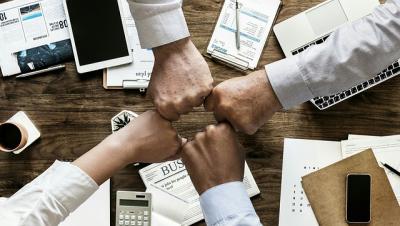 quattro pugni di uomini che si toccano